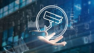 View of Businessman holding Security camera system icon and statistics data - 3d rendering